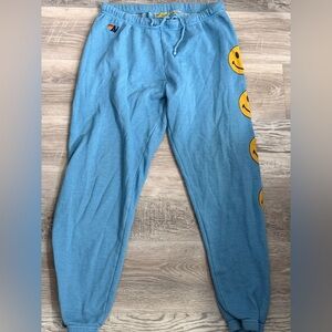 Aviator Nation Blue Sweatpants with Yellow Smiley Design